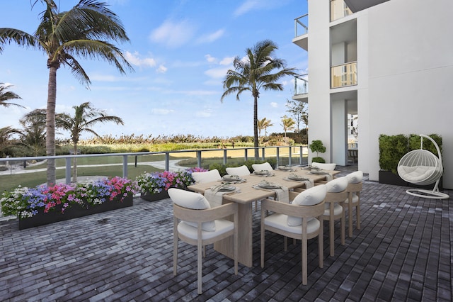 view of patio featuring a balcony and a water view