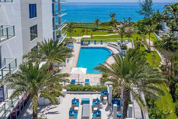 view of swimming pool with a water view and a patio area