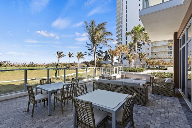 view of patio / terrace with a balcony and an outdoor living space