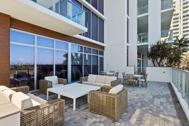 patio terrace at dusk featuring an outdoor hangout area