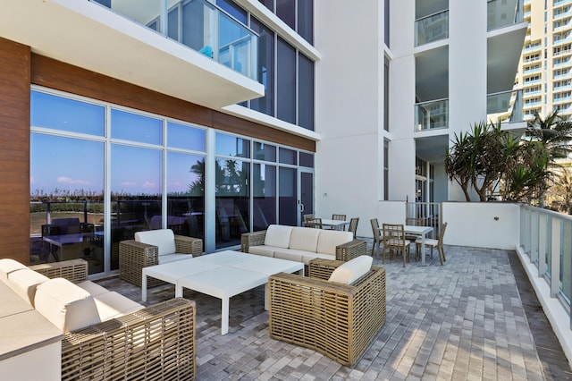 patio terrace at dusk with an outdoor living space and outdoor dining area