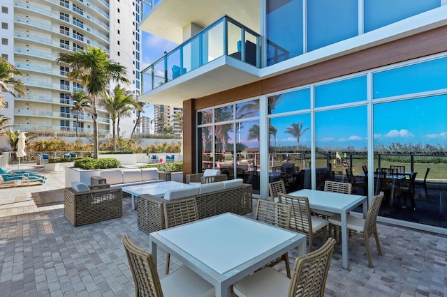 view of patio featuring outdoor lounge area, outdoor dining space, and a balcony