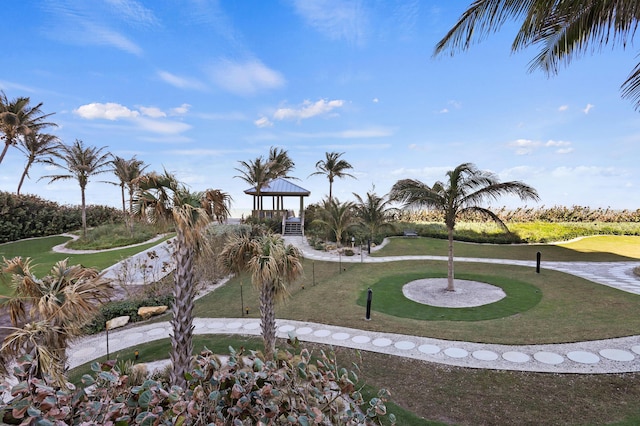 view of home's community featuring a lawn and golf course view