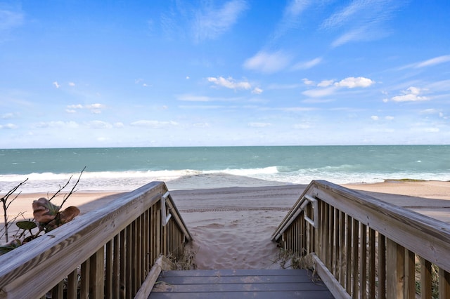 view of property's community featuring a beach view and a water view