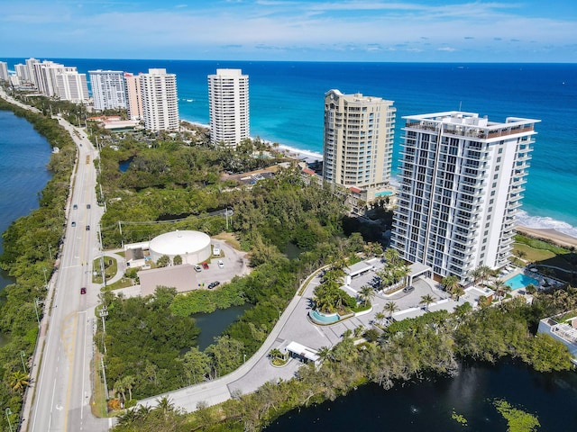drone / aerial view featuring a water view and a view of city
