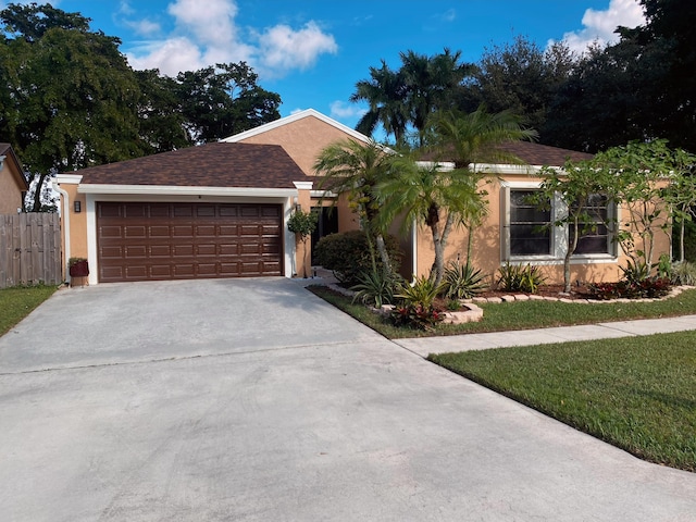 ranch-style house featuring a front yard and a garage