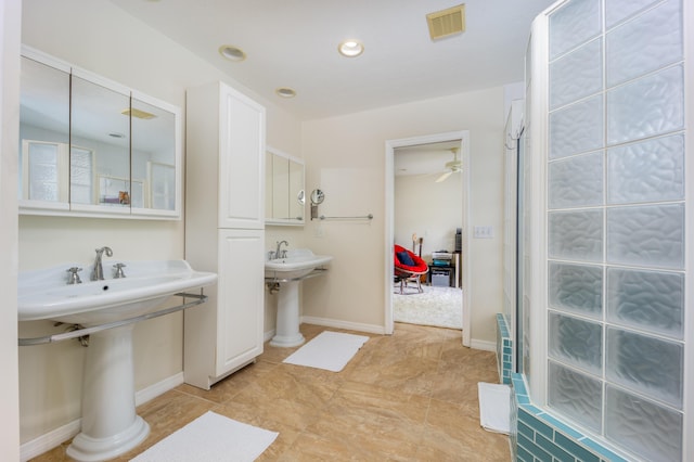1121 SW Pine Tree Ln, Palm City, FL 34990 - bathroom with ceiling fan, a sink, and tile patterned floors