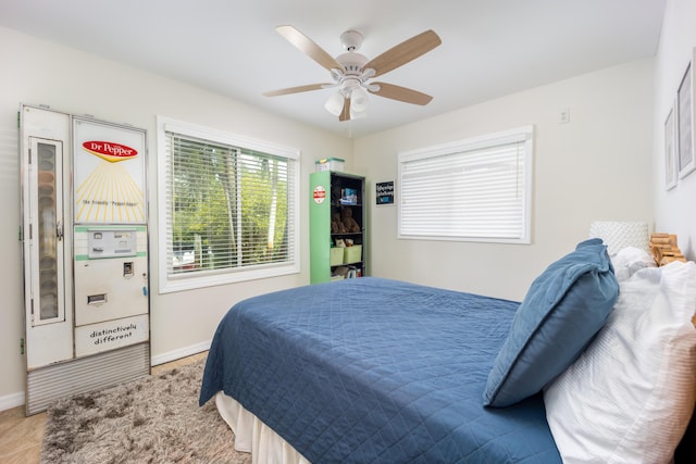 1121 SW Pine Tree Ln, Palm City, FL 34990 - bedroom with baseboards and ceiling fan
