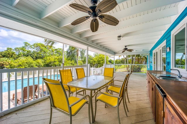 1121 SW Pine Tree Ln, Palm City, FL 34990 - sunroom / solarium featuring a sink, ceiling fan, outdoor dining area, and beam ceiling