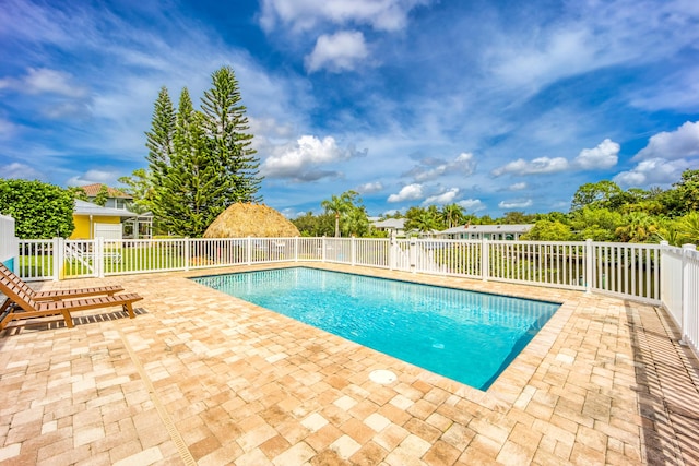 1121 SW Pine Tree Ln, Palm City, FL 34990 - view of swimming pool featuring a patio area and fence
