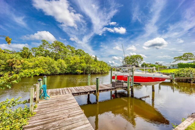 1121 SW Pine Tree Ln, Palm City, FL 34990 - dock area with a water view and boat lift
