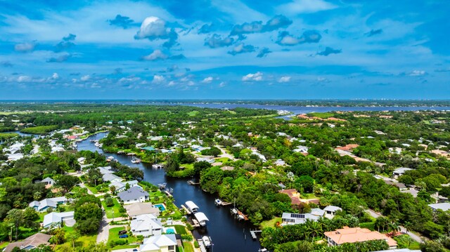 1121 SW Pine Tree Ln, Palm City, FL 34990 - aerial perspective of suburban area featuring a nearby body of water