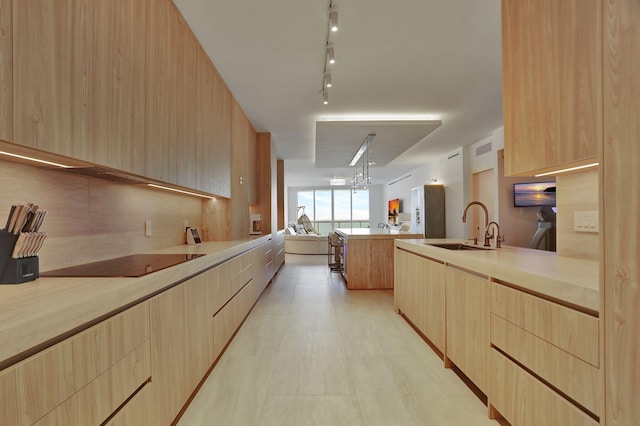 704 N Ocean Blvd Unit 602, Pompano Beach, FL 33062 - kitchen featuring light brown cabinetry, a sink, and open floor plan