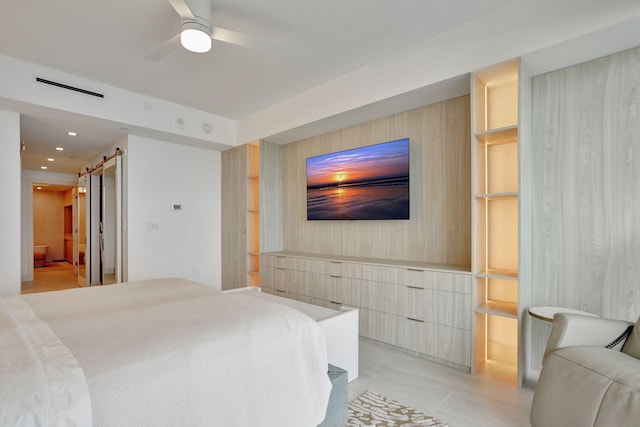 704 N Ocean Blvd Unit 602, Pompano Beach, FL 33062 - bedroom with a barn door, an accent wall, ceiling fan, and recessed lighting