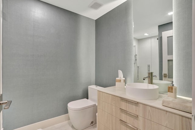 bathroom with vanity, tile patterned flooring, and toilet