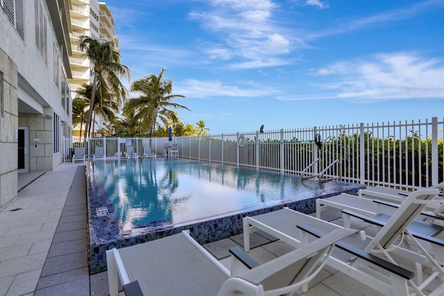 view of swimming pool featuring a patio area