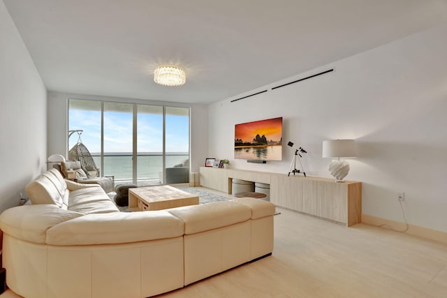 living room with floor to ceiling windows and light wood-type flooring