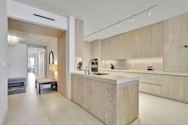 704 N Ocean Blvd Unit 602, Pompano Beach, FL 33062 - kitchen featuring modern cabinets, light brown cabinetry, light countertops, rail lighting, and light tile patterned flooring
