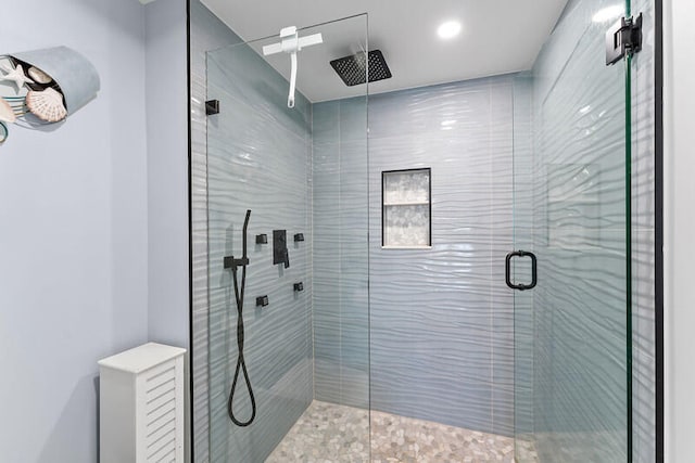 bathroom with a shower with door