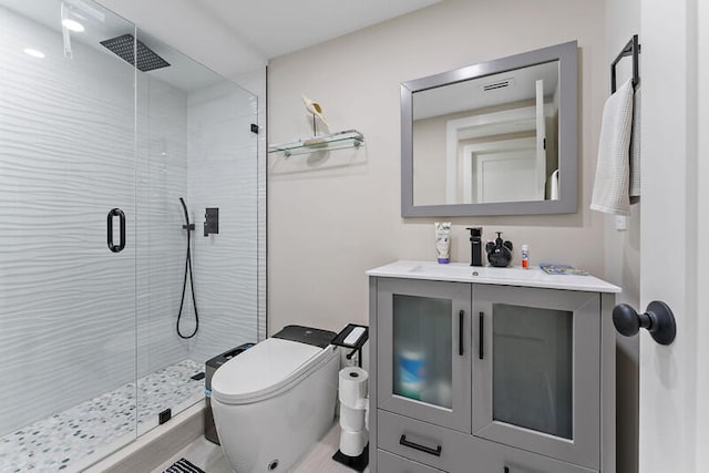 bathroom featuring toilet, vanity, and walk in shower