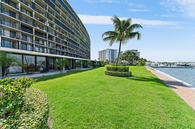 surrounding community featuring a yard and a water view