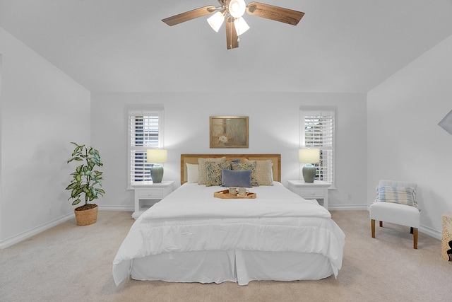 bedroom with ceiling fan and light colored carpet