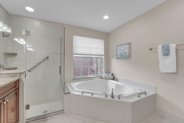 bathroom with tile patterned flooring, vanity, and plus walk in shower