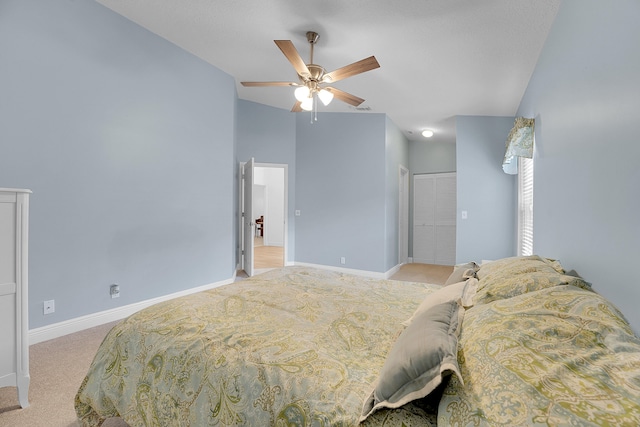 carpeted bedroom featuring ceiling fan and a closet