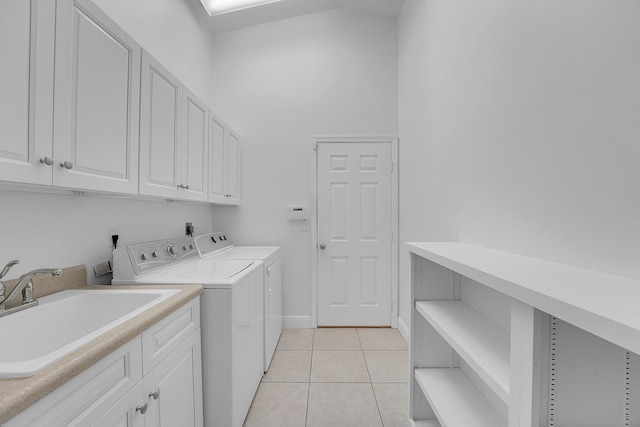 laundry area featuring cabinets, independent washer and dryer, light tile patterned flooring, and sink