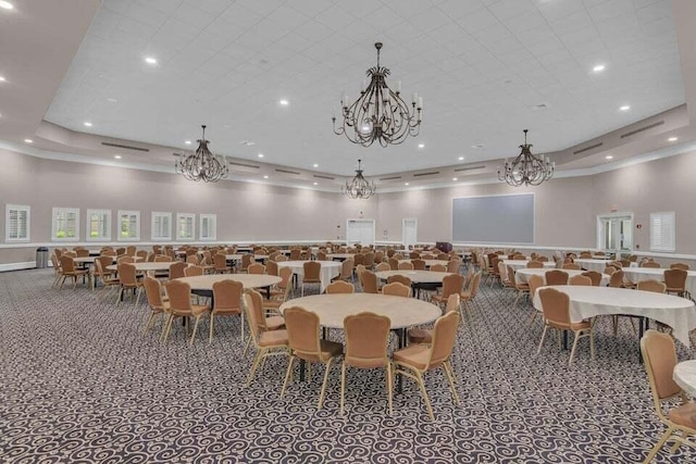 carpeted dining area with a tray ceiling, a towering ceiling, and a chandelier