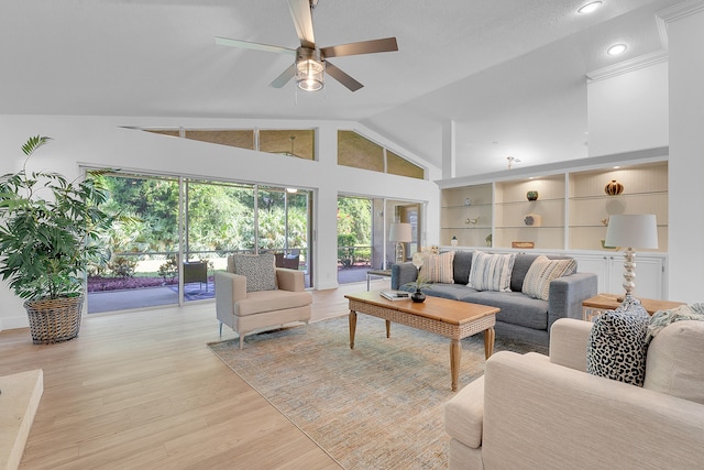 living room with ceiling fan, vaulted ceiling, a textured ceiling, and light hardwood / wood-style floors