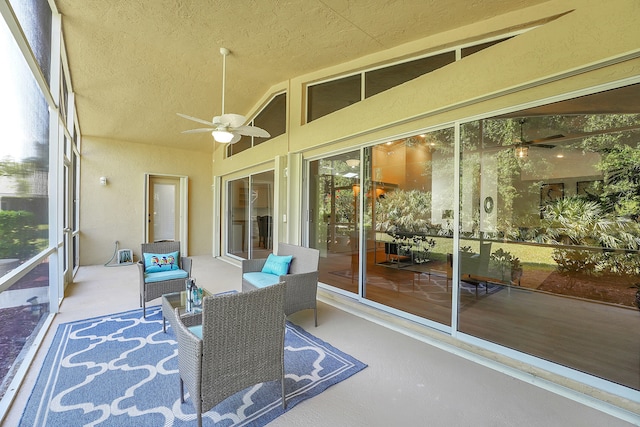 sunroom / solarium with ceiling fan and vaulted ceiling