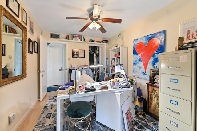 office with ceiling fan and light hardwood / wood-style floors