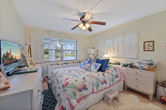 bedroom with ceiling fan and light colored carpet