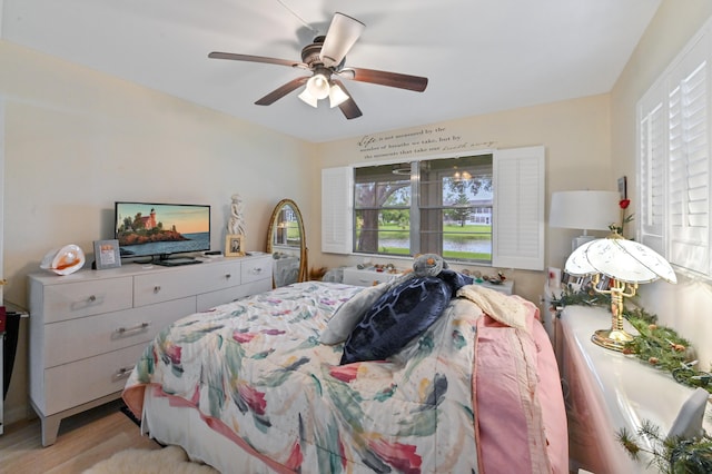 bedroom with light wood-type flooring and ceiling fan