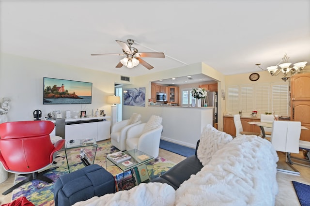 living room featuring ceiling fan with notable chandelier