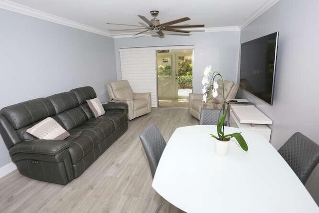 living room with ceiling fan, crown molding, and light hardwood / wood-style floors