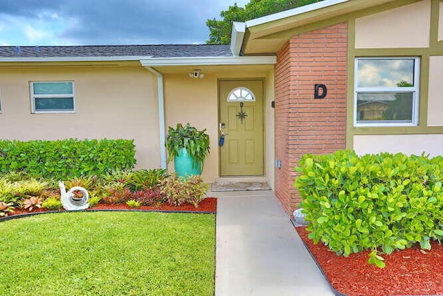 entrance to property with a lawn