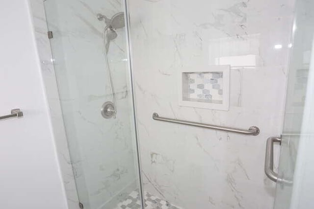 bathroom with a shower with door