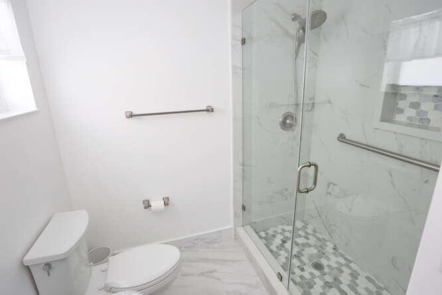 bathroom with walk in shower and toilet