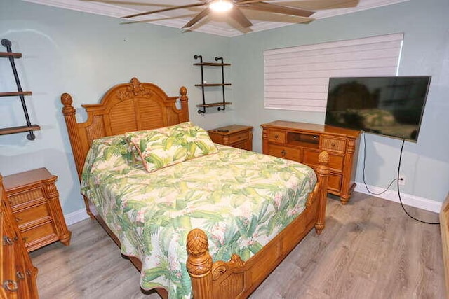 bedroom featuring ceiling fan, light hardwood / wood-style flooring, and crown molding