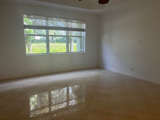 unfurnished room featuring tile patterned floors and ceiling fan