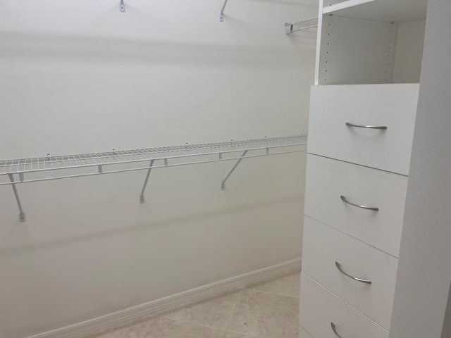 spacious closet featuring light tile patterned floors