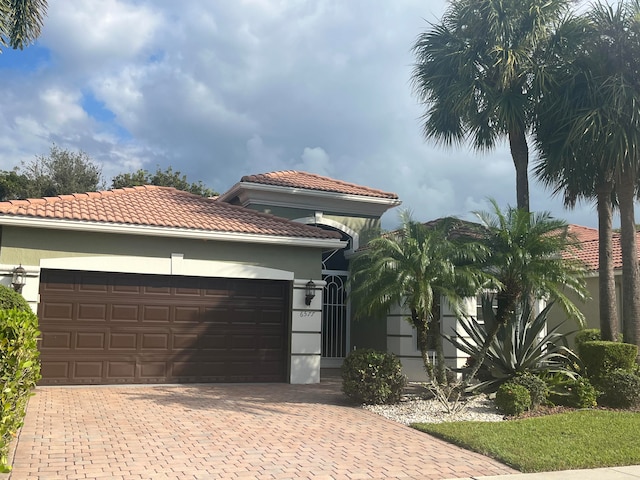 mediterranean / spanish-style house with a garage