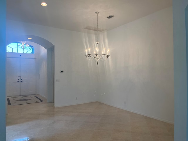 foyer entrance with a notable chandelier