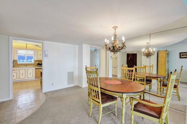 dining room with ceiling fan with notable chandelier