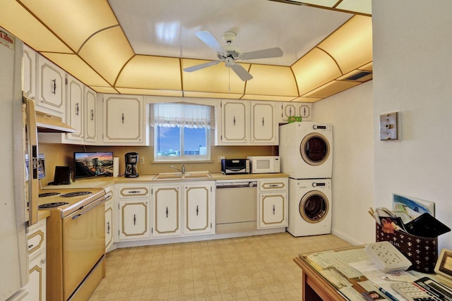 kitchen with stacked washing maching and dryer, white appliances, ventilation hood, ceiling fan, and sink