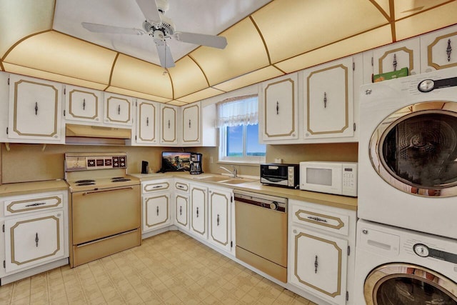 kitchen with ceiling fan, stove, sink, stainless steel dishwasher, and stacked washer / drying machine