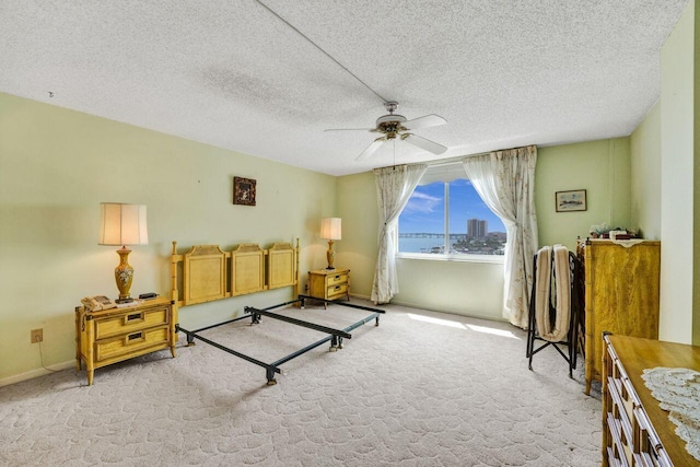 interior space with a textured ceiling and ceiling fan