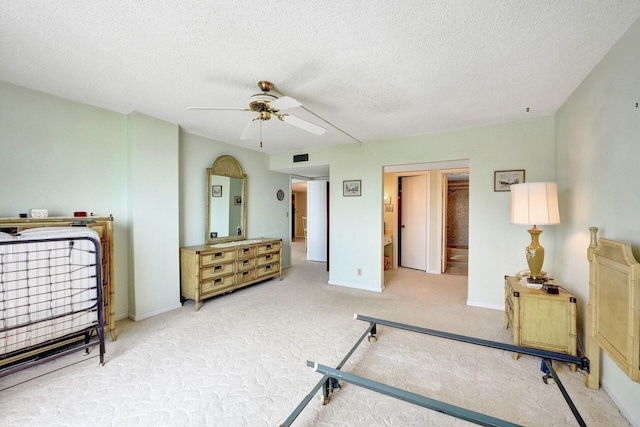 exercise room with a textured ceiling, ceiling fan, and carpet floors